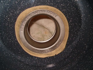 Inside view of the pot and flange with putty squeezing out